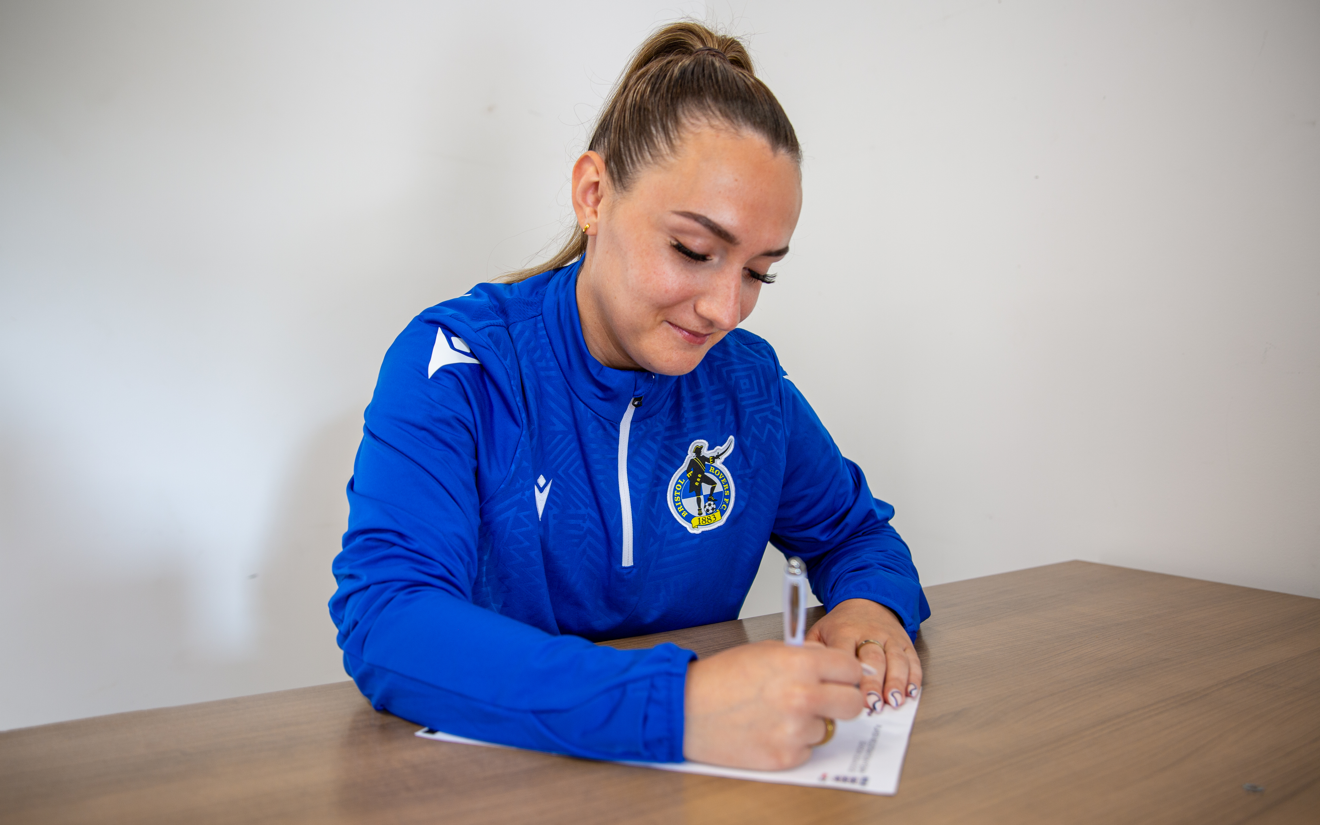 Charlotte Buxton signing a contract