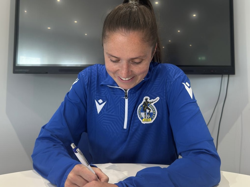 Chloe Bassett signing a contract.