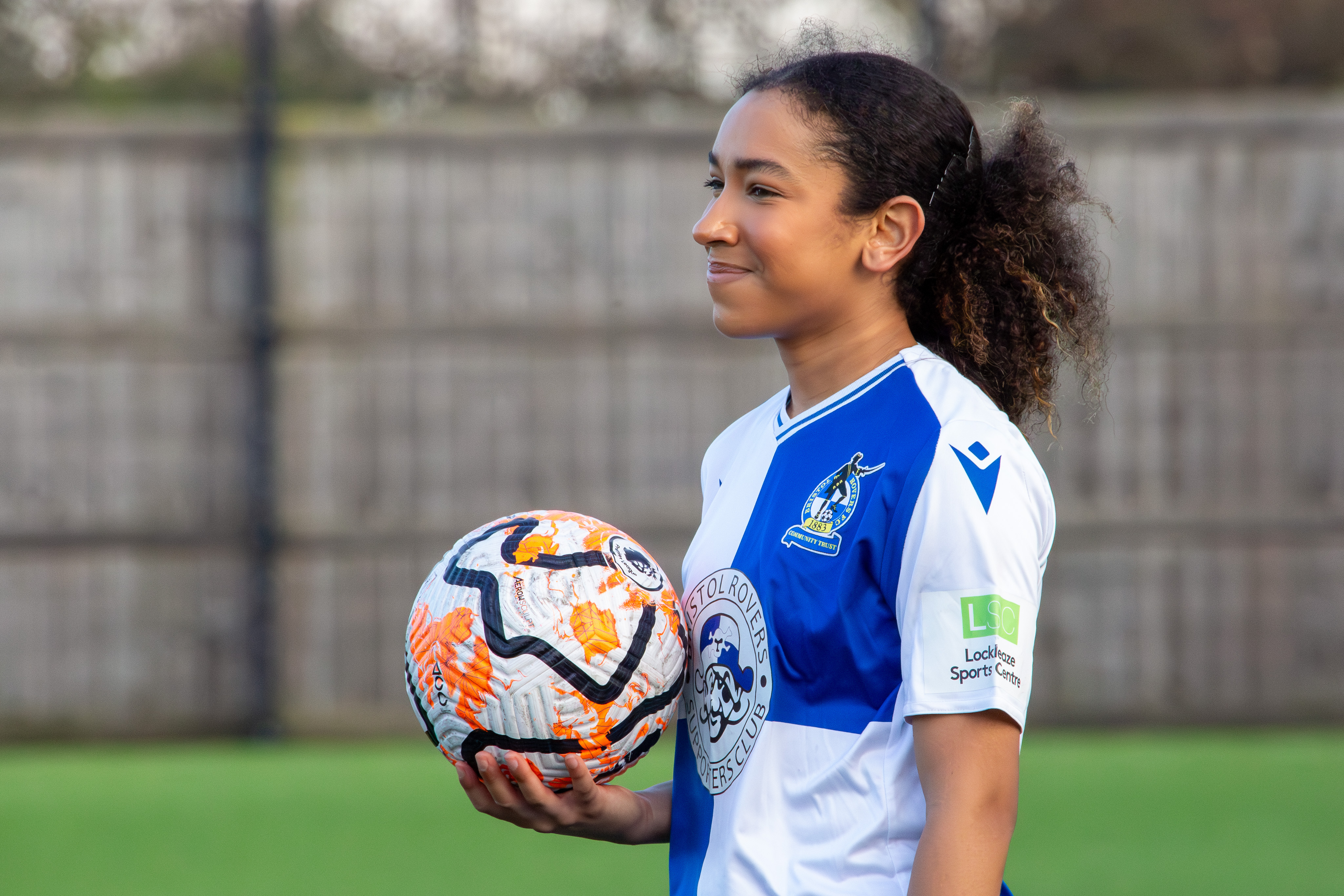 Layah Douglas holding a football.