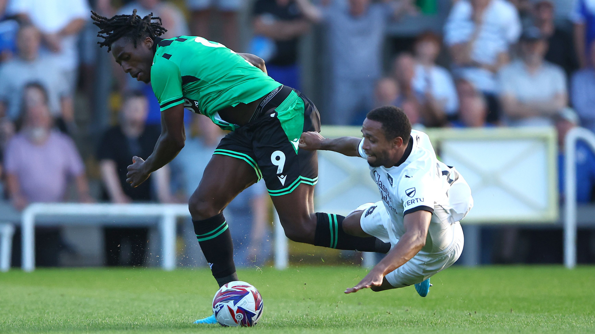 Promise Omochere of Bristol Rovers and Brendan Galloway of Plymouth Argyle in action