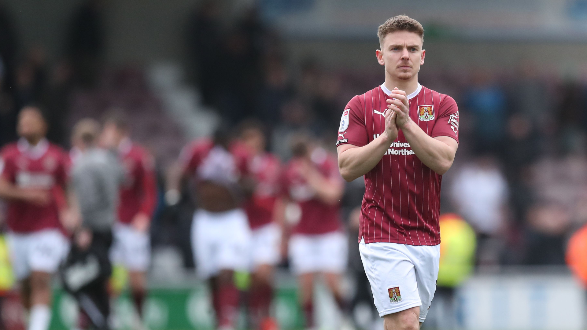 Sam Hoskins of Northampton Town applauds the fans