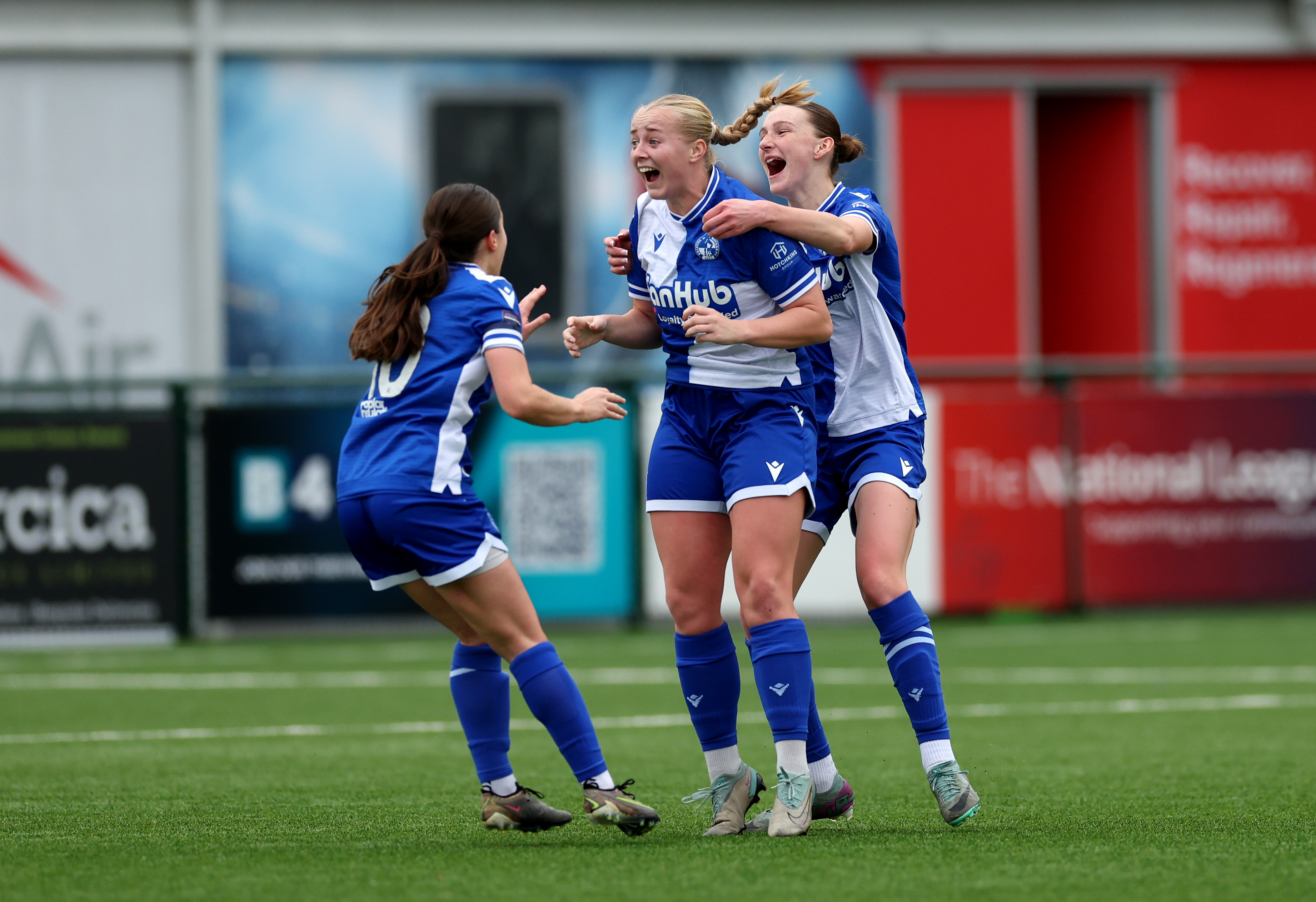 Meg Jarvis, Emison Evans and Nia Rees celebrate Meg's goal.