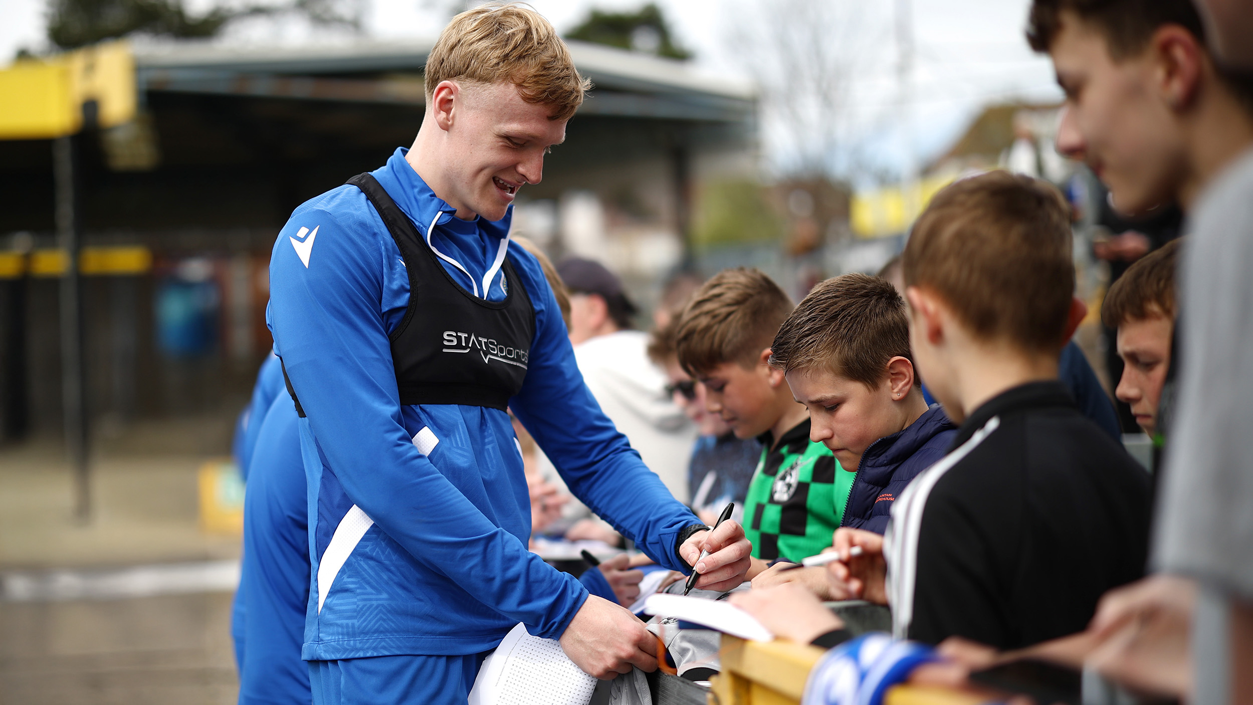 Connor Taylor signs a shirt at a fan event