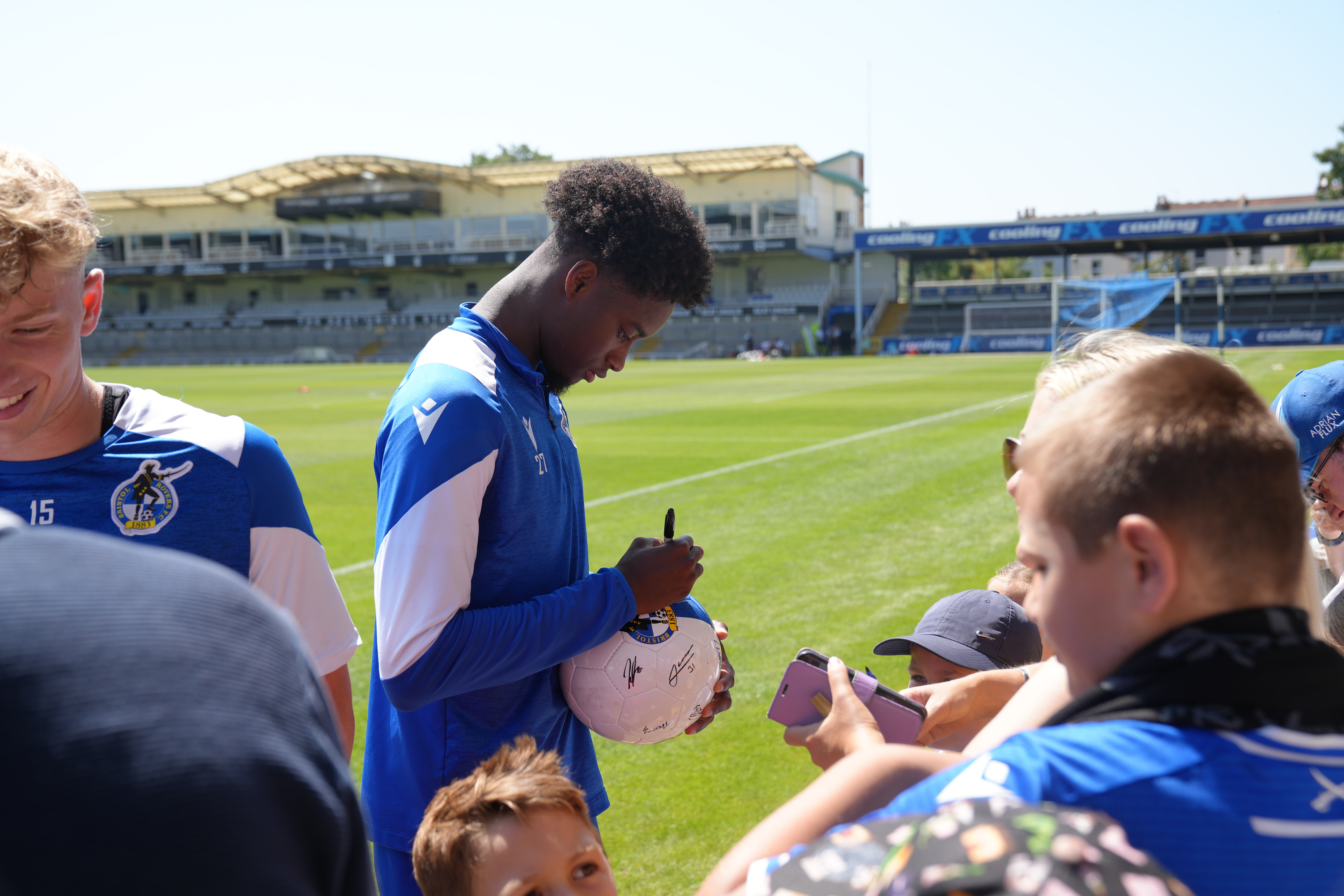 Bristol Rovers player signing ball