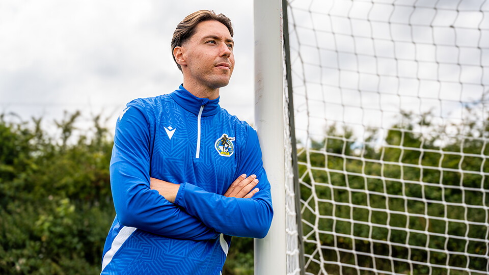 Isaac Hutchinson leans on a goal post