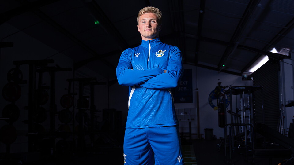 Taylor Moore arms crossed in the gym