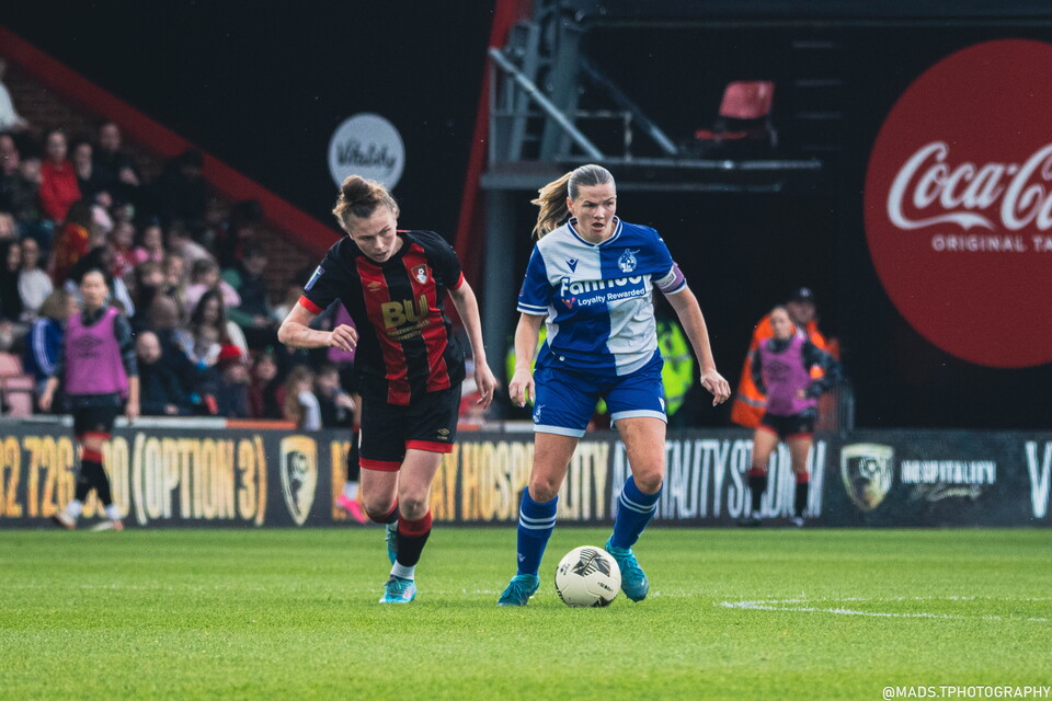 Rovers Captain Rianne Bourne-Hallett controls the ball mid-game whilst being pressured by AFC Bournemouth's Ellie Strippel, at The Vitality Stadium.