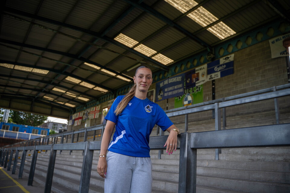 Chloe Gilroy leans against a post in the Thatchers End at the Memorial Stadium.