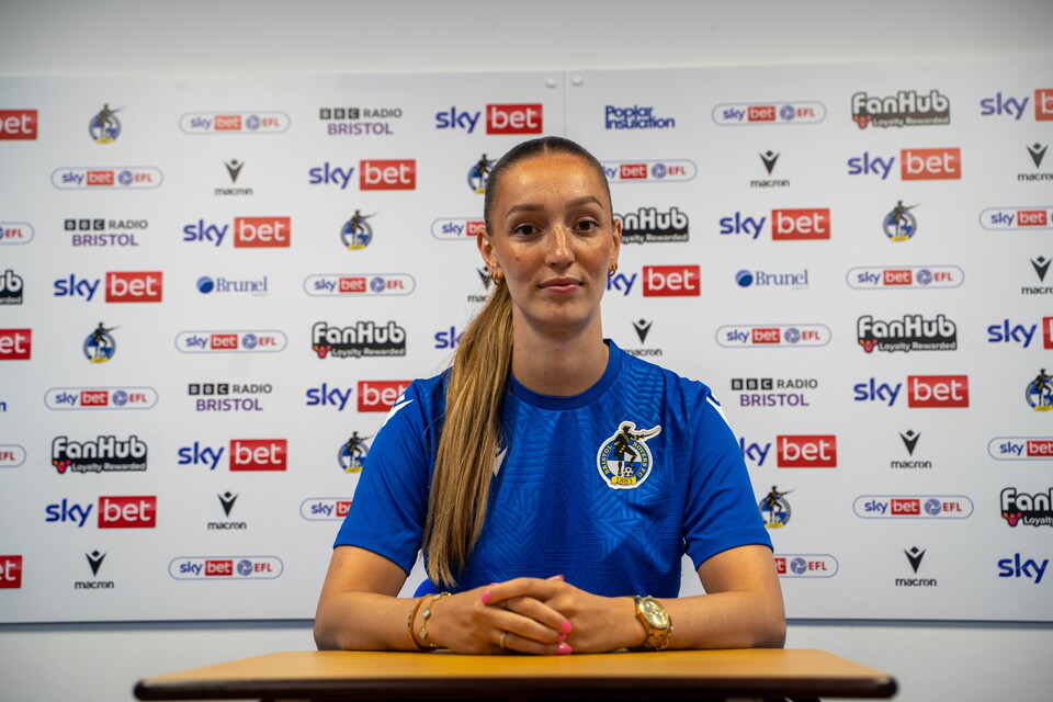 Chloe Gilroy in a Bristol Rovers shirt during a press conference.