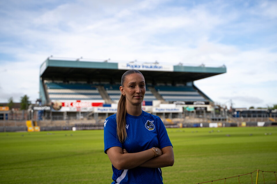 Chloe Gilroy in a Bristol Rovers shirt on the grass of the Memorial Stadium..