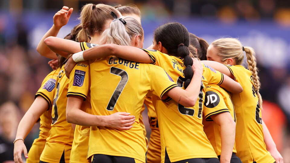 Wolves Ladies celebrate a goal.