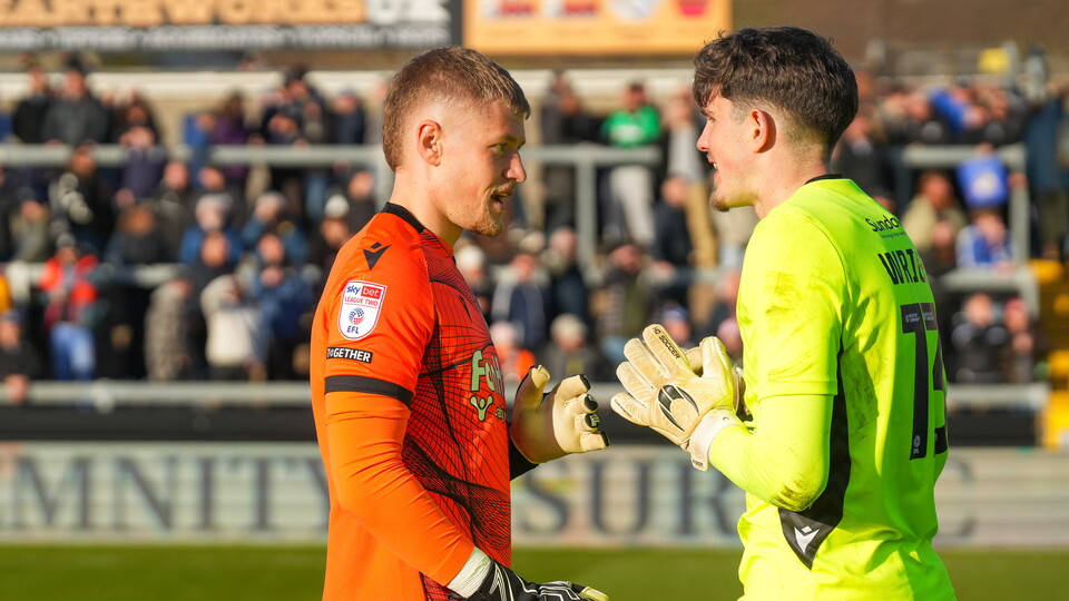 Brad Young talking to Accrington Stanley goalkeeper Ollie Clarke
