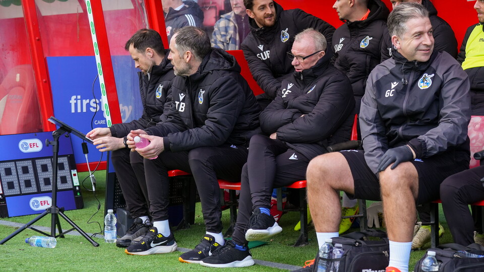 Steve Evans in the dugout of The Nigel Eady County Ground