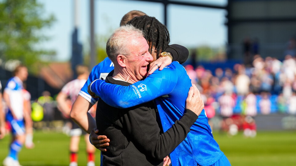 Steve Evans hugs Shaq Forde after Cheltenham Town win