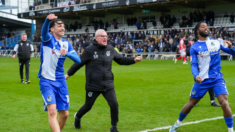 Steve Evans celebrates Fleetwood Town victory with Yusuf Akhamrich and Shaq Forde