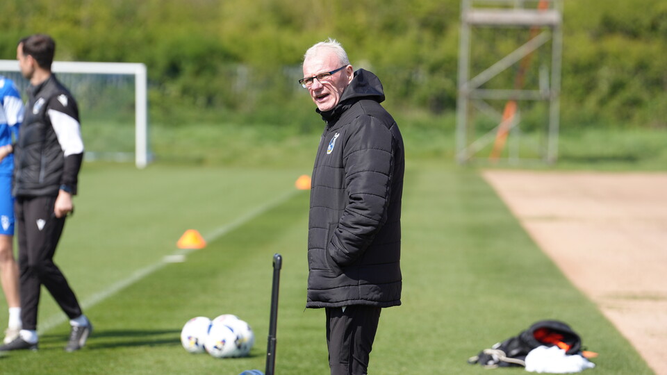 Steve Evans watches his team on the training pitch