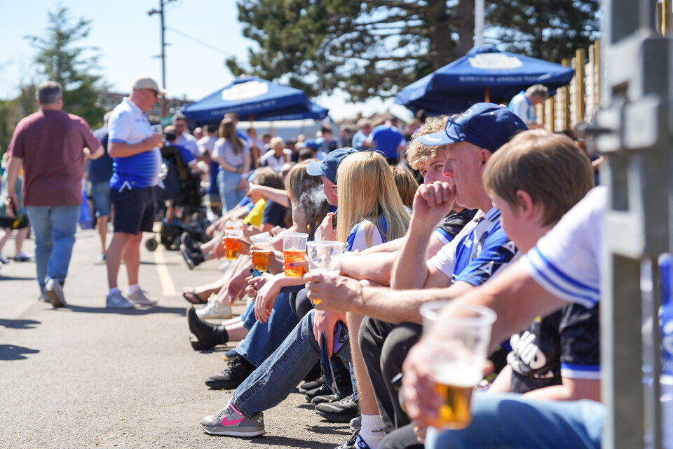 Supporters sitting in Fanzone