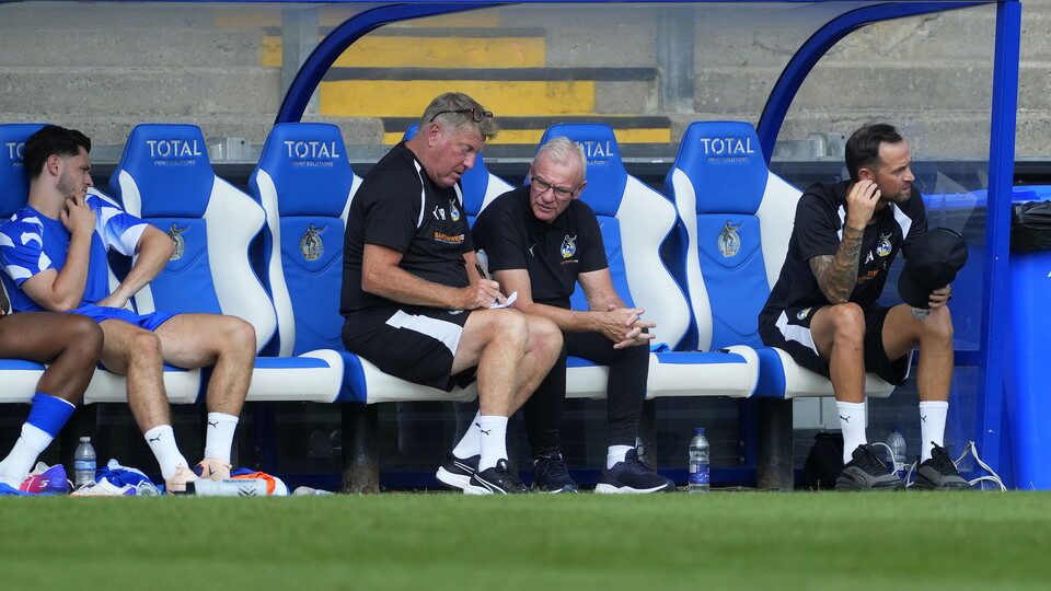 Steve Evans and Paul Raynor in the dugout during the Portsmouth game