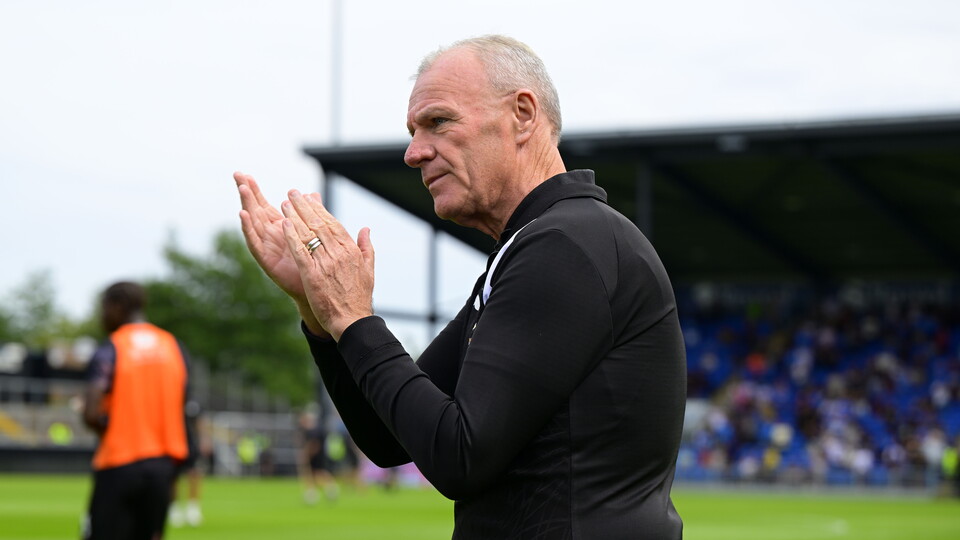 Steve Evans applauds fans at the end of the Peterborough match