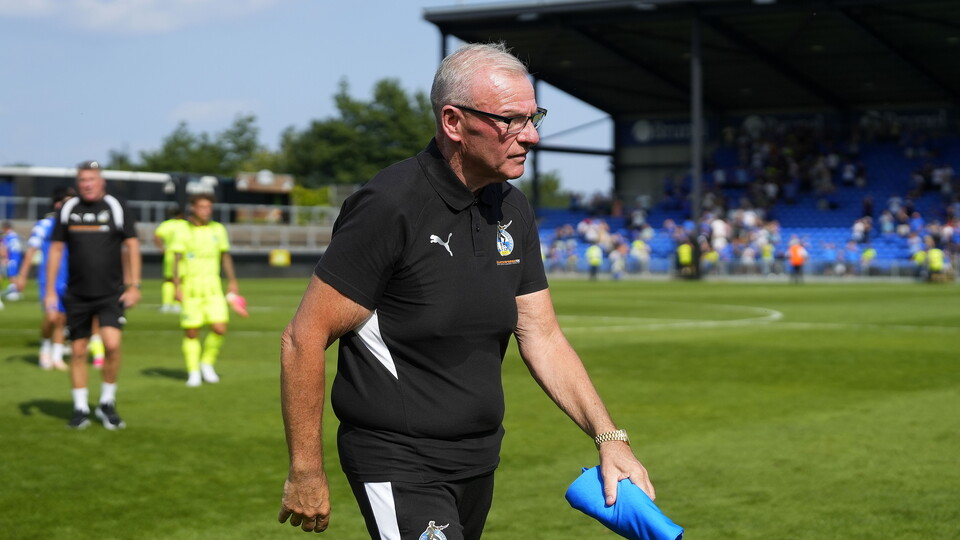 Steve Evans walking off of the pitch at the Memorial Stadium