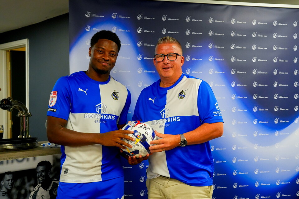 Bobby Kamwa presenting match ball to sponsor