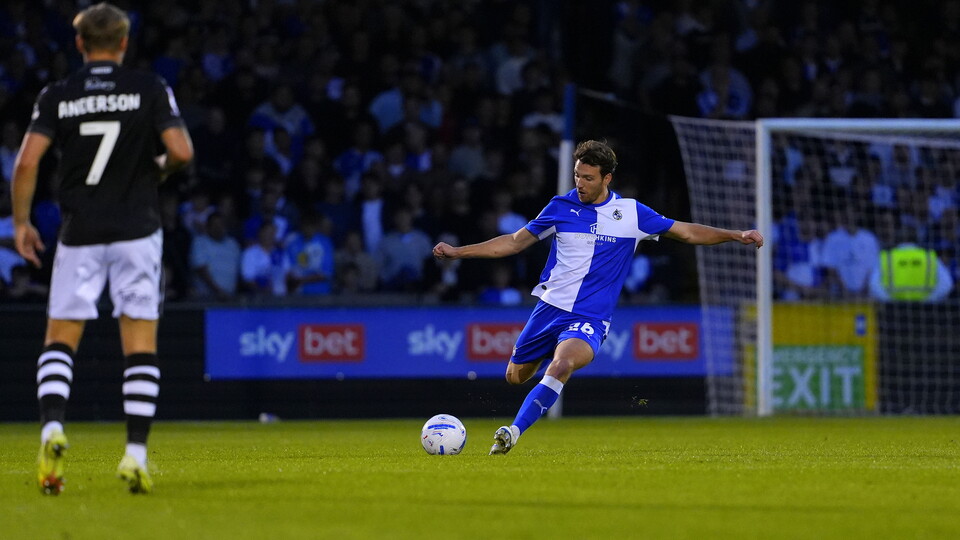 Riley Harbottle kicking the ball across the pitch
