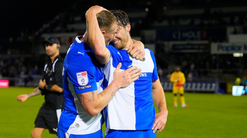 Riley Harbottle hugs Ciarán Kelly after Bristol Rovers' match