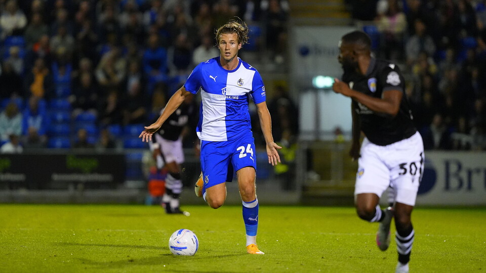 Tommy Leigh is marked by a Colchester defender
