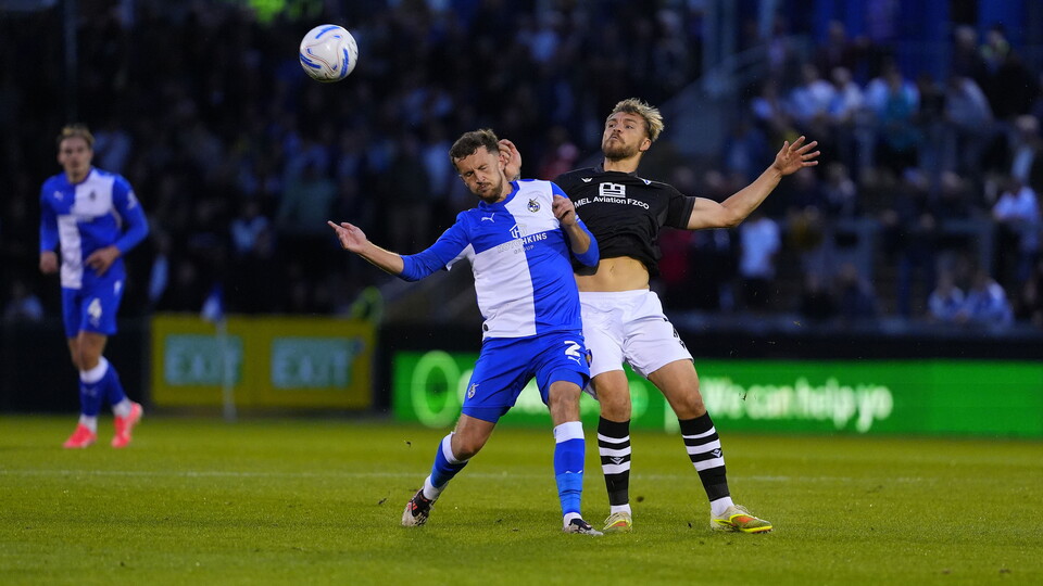 Tom James heads a ball away from a Colchester forward