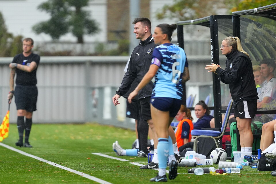 Nathan Hallett-Young smiling on the touchline