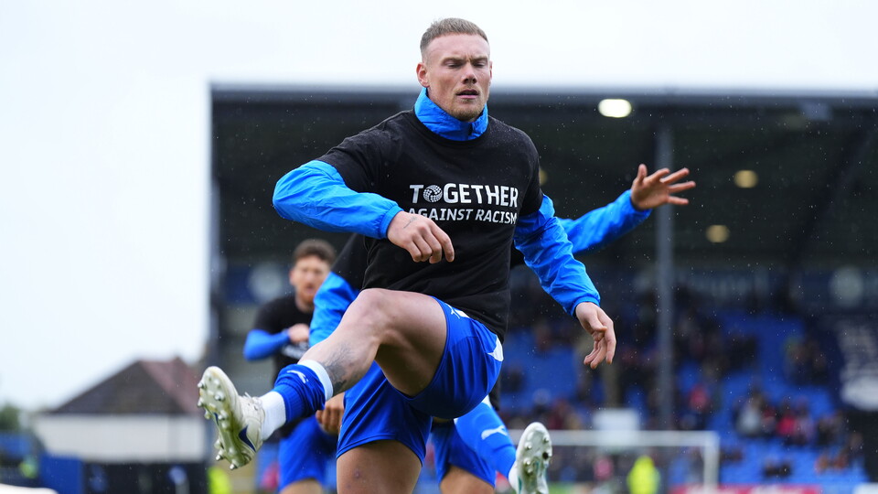 Ciaran Kelly warms up before the match