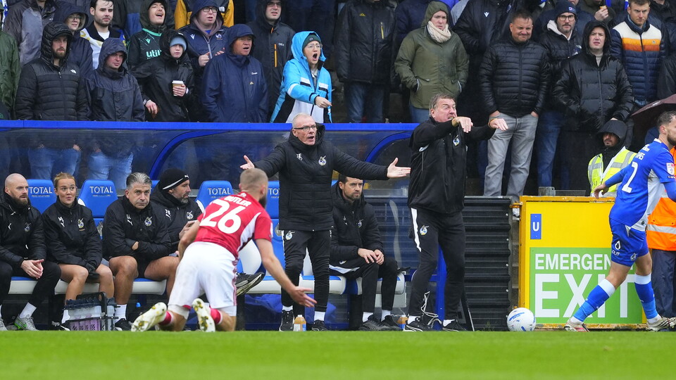 Steve Evans and Paul Raynor watching on from the touchline
