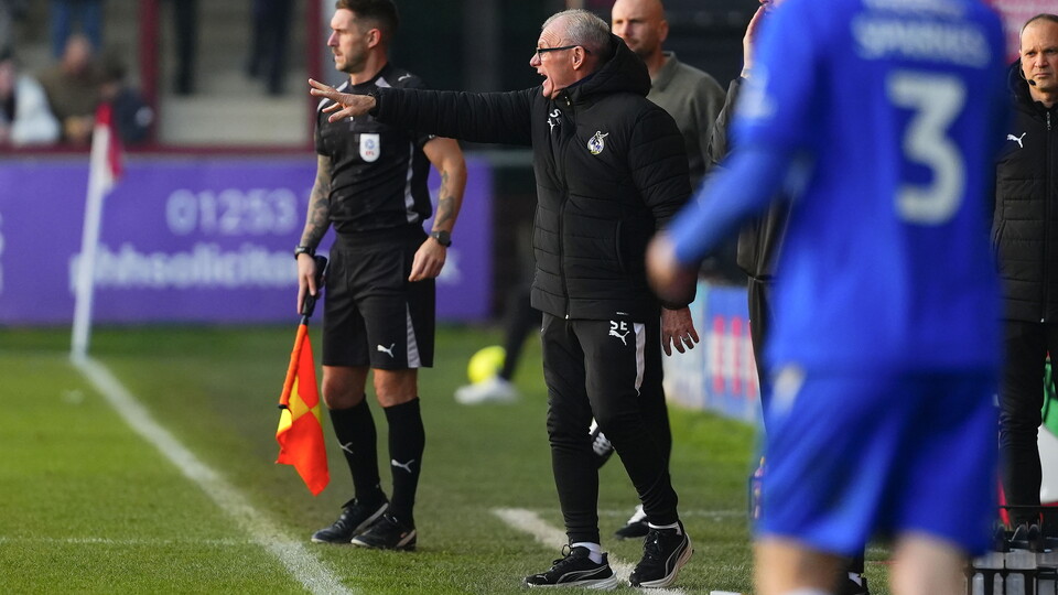 Steve Evans shouts to players from the touch line