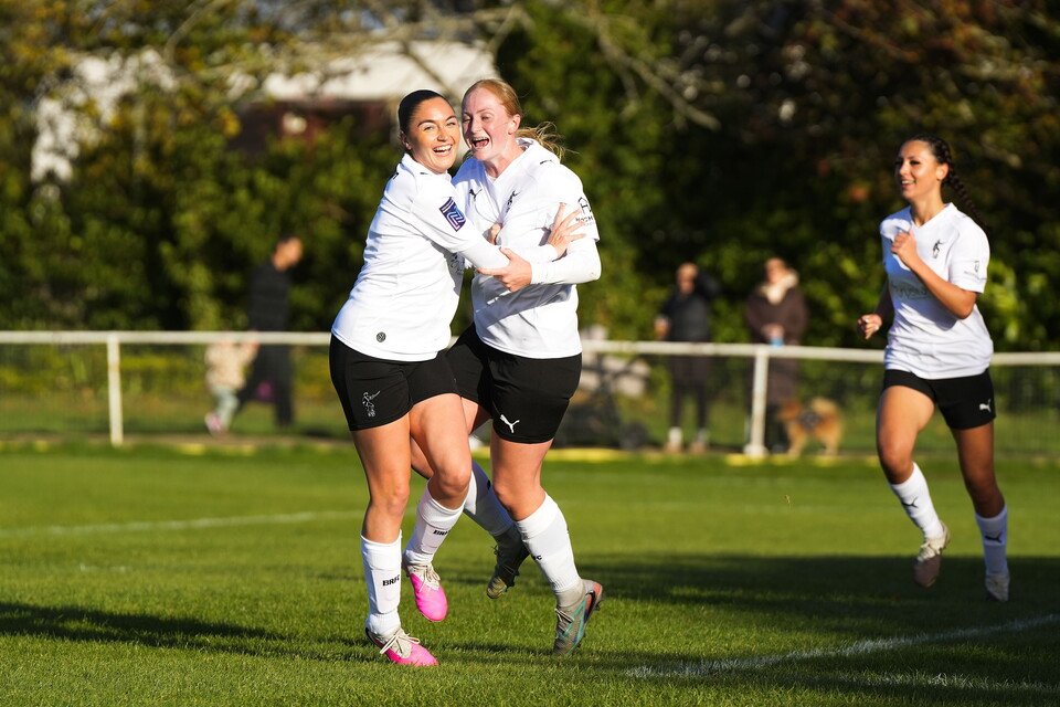 Gipsy Viveash and Libby Davies celebrating after scoring a goal.