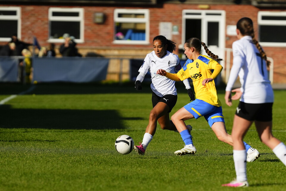 Layah Douglas on the ball, pressured by an Abingdon defender.