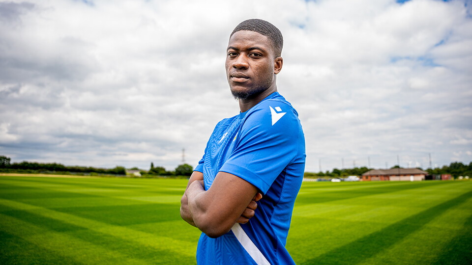 Clinton Mola poses for his signing portrait