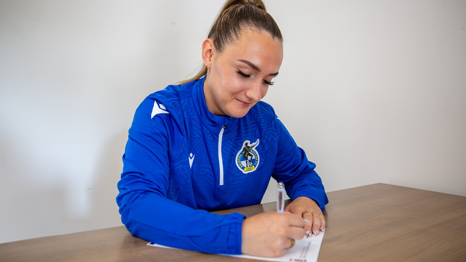 Charlotte Buxton signing a contract