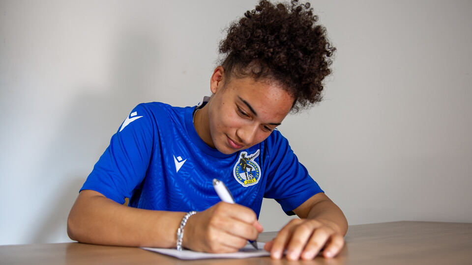 Tyra Wilson signing a contract