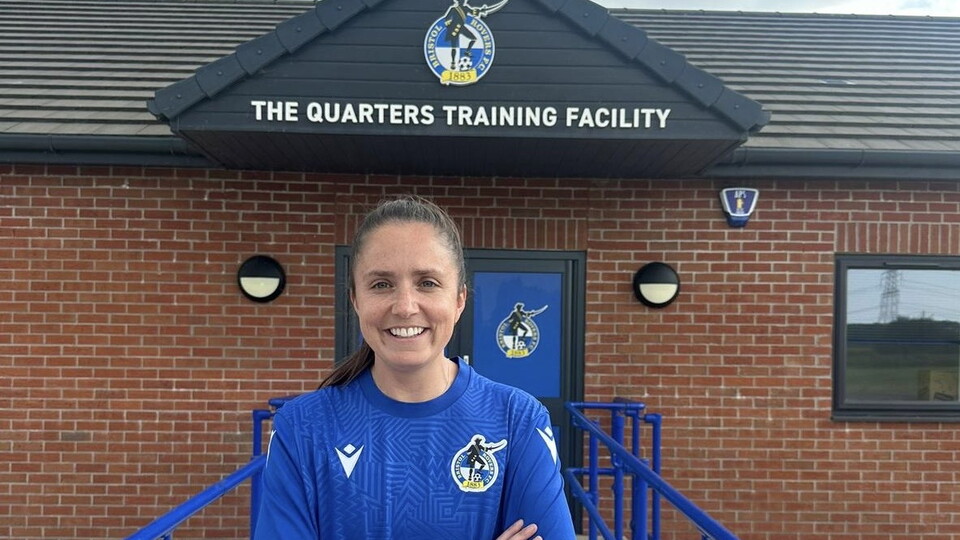 Chloe Bassett standing in front of The Quarters.