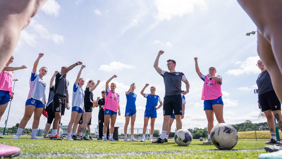 BRWFC players hold their fists up in the air.