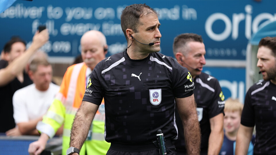  Referee Alex Chilowicz walks out ahead of the match