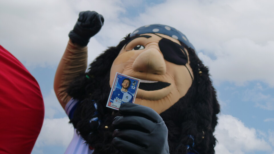 Captain Gas holding Tom Lockyer sticker